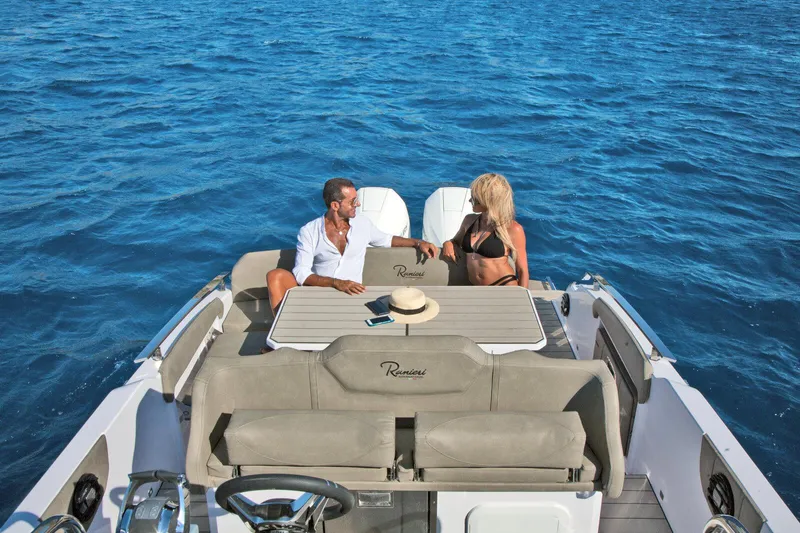  Yacht Photos Pics Couple relaxing on a 2025 Ranieri NEXT 285 XL boat in open water.