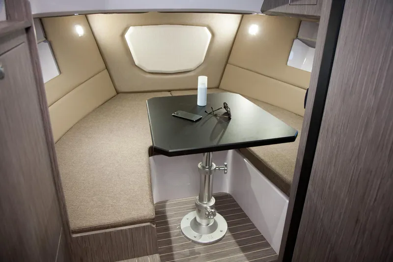  Yacht Photos Pics 2025 Ranieri NEXT 285 XL cabin interior with table, beige seating, and modern design.