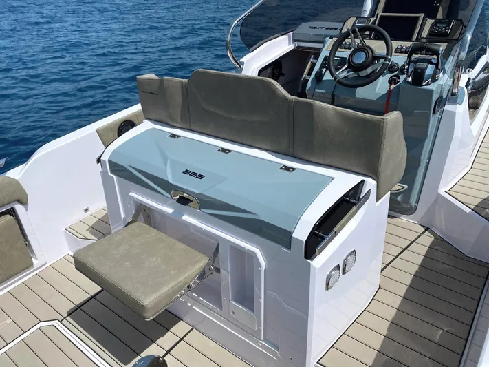 Yacht Photos Pics 2025 Ranieri NEXT 285 XL boat interior with seating and steering console on open water.