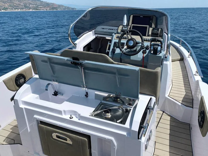  Yacht Photos Pics 2025 Ranieri NEXT 285 XL boat interior with steering console and kitchenette on open sea.
