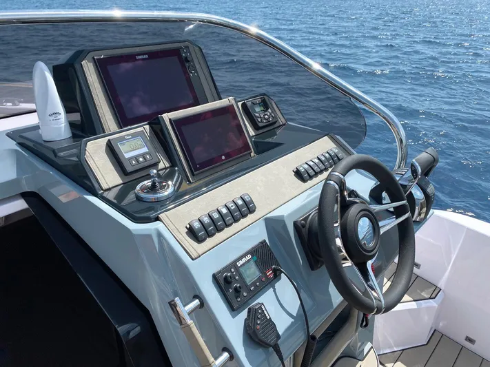  Yacht Photos Pics 2025 Ranieri NEXT 285 XL boat dashboard with navigation screens and steering wheel.