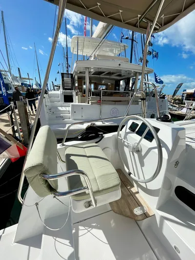 Tbd Yacht Photos Pics 2026 Bali CATSMART yacht helm with cushioned seat and steering wheel at marina.
