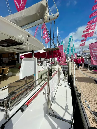 Tbd Yacht Photos Pics 2026 Bali CATSMART catamaran docked at marina with vibrant flags and clear blue sky.