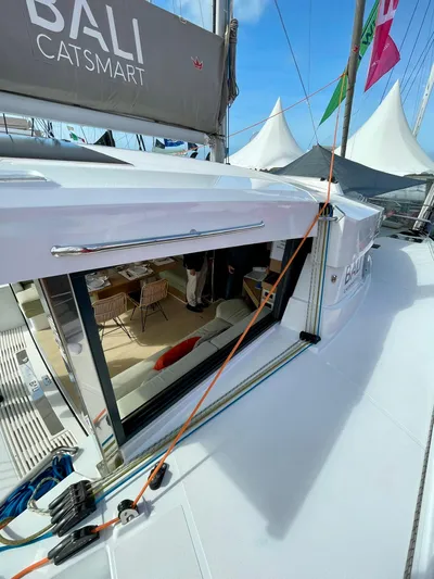 Tbd Yacht Photos Pics 2026 Bali CATSMART yacht with open deck and modern interior at a marina.