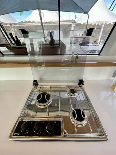 Tbd Yacht Photos Pics Modern Bali CATSMART 2026 stove with three burners and glass cover in a sleek kitchen setting.