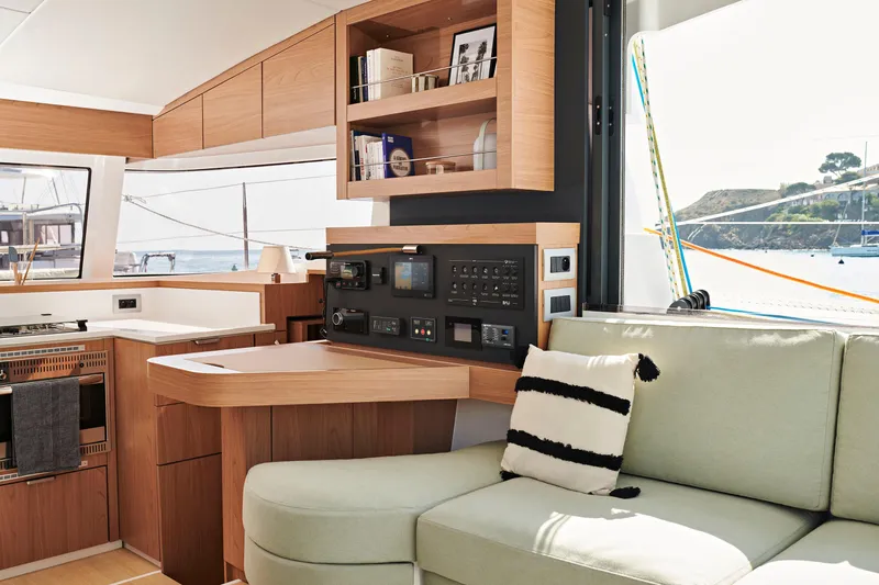 Tbd Yacht Photos Pics Modern Bali CATSMART 2026 yacht interior with light wood cabinetry and cozy seating area.