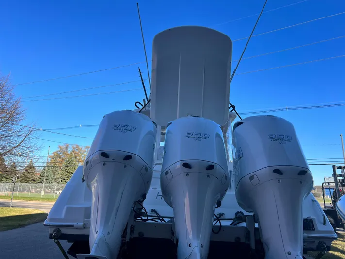 Ghost Yacht Photos Pics 2012 Everglades 350LX boat with triple outboard engines, viewed from the rear.