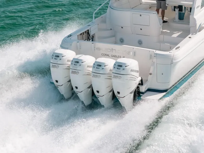  Yacht Photos Pics 2009 Intrepid 475 Sport Yacht with four powerful outboard engines cruising on water.