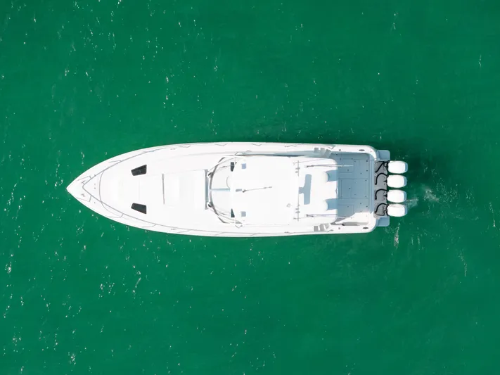  Yacht Photos Pics Aerial view of 2009 Intrepid 475 Sport Yacht on turquoise water.