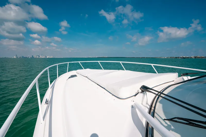  Yacht Photos Pics 2009 Intrepid 475 Sport Yacht cruising on open water under a clear blue sky.