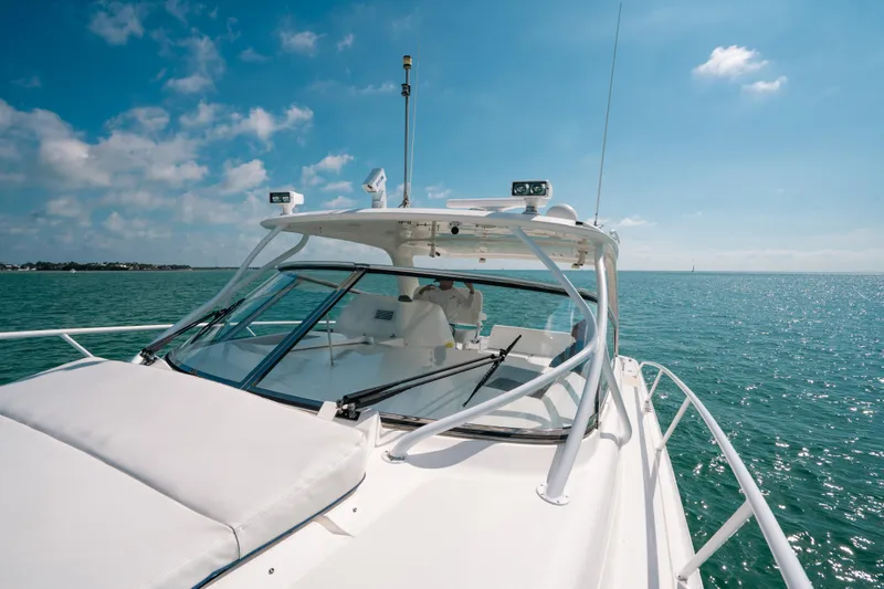  Yacht Photos Pics 2009 Intrepid 475 Sport Yacht cruising on a sunny day, clear blue waters.