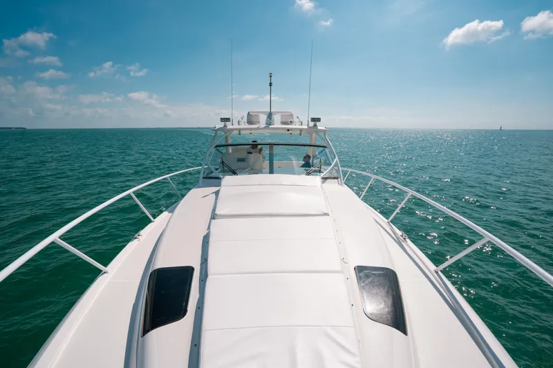  Yacht Photos Pics 2009 Intrepid 475 Sport Yacht cruising on open sea under clear blue sky.