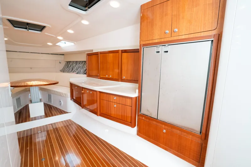  Yacht Photos Pics Interior of 2009 Intrepid 475 Sport Yacht with wooden cabinetry and sleek design.