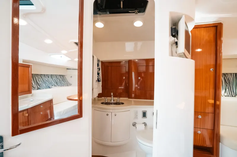  Yacht Photos Pics Interior of 2009 Intrepid 475 Sport Yacht featuring modern bathroom and wood accents.