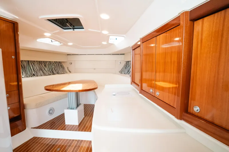  Yacht Photos Pics Luxurious interior of 2009 Intrepid 475 Sport Yacht with wooden cabinetry and seating area.