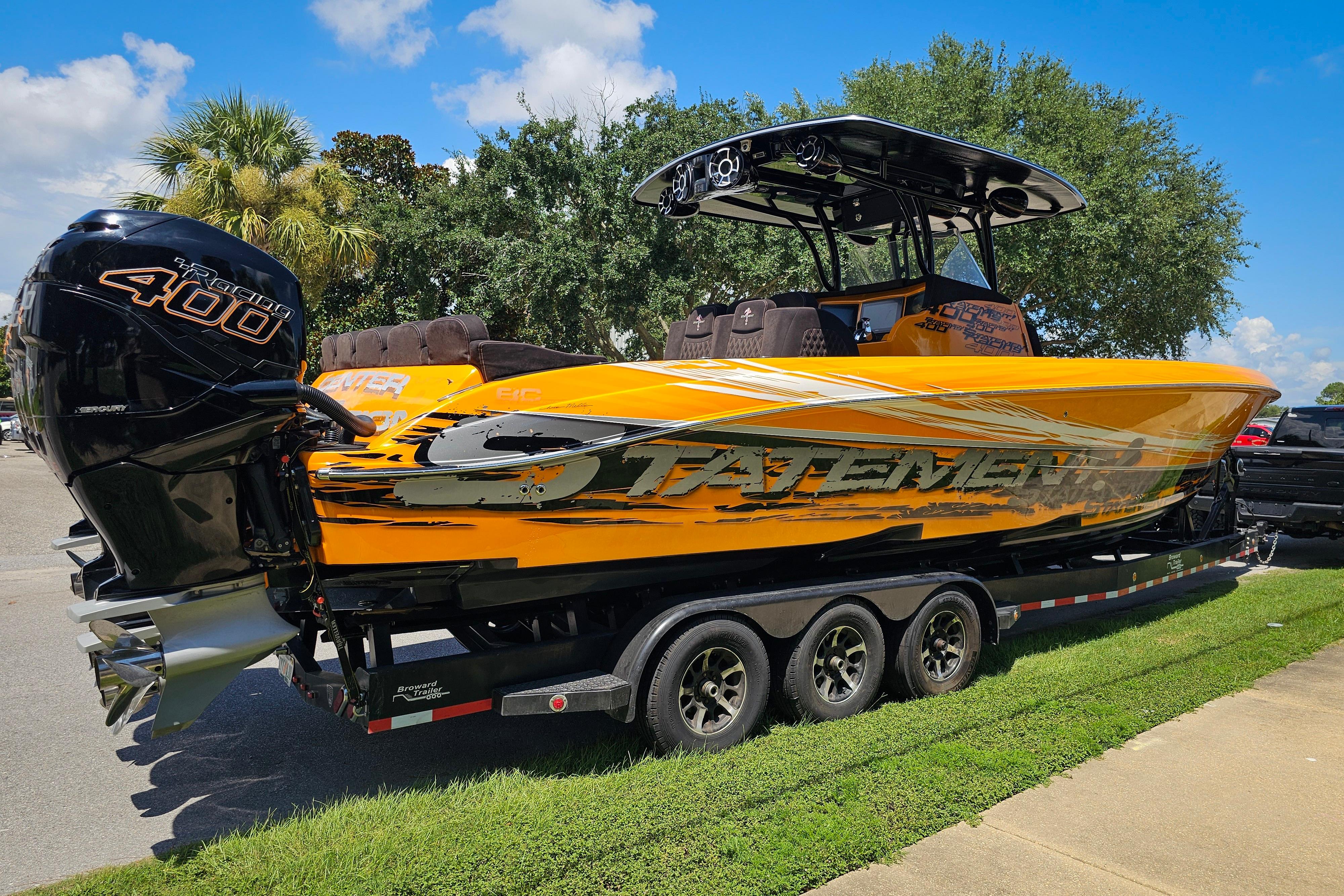 Orange 2016 Statement 380 Open boat on trailer, featuring powerful Mercury 400R engine.