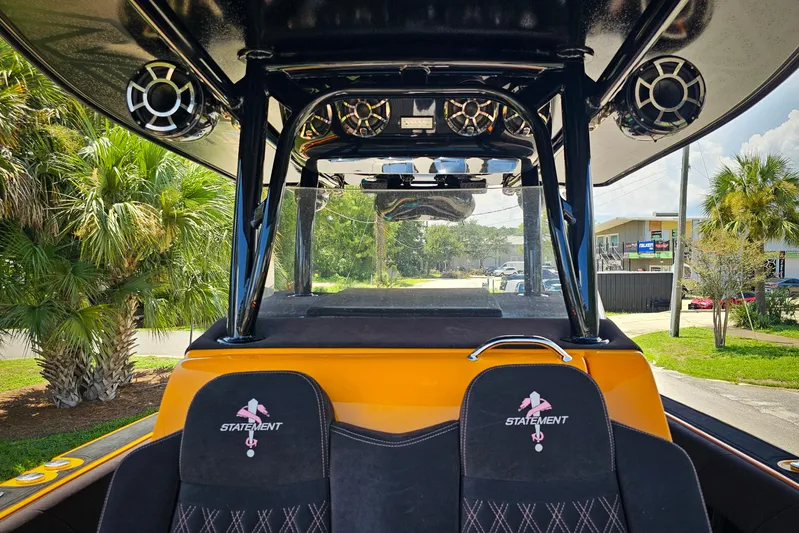  Yacht Photos Pics 2016 Statement 380 Open boat interior with speakers and branded seats, surrounded by palm trees.