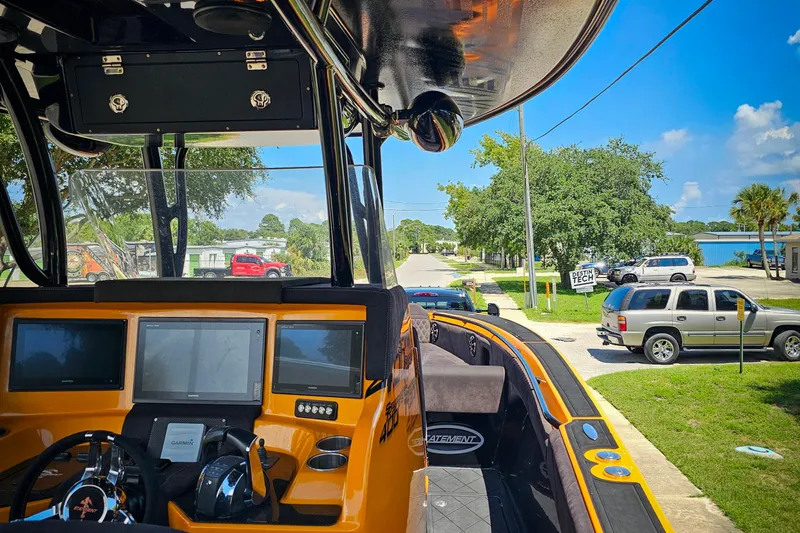  Yacht Photos Pics Interior view of a 2016 Statement 380 Open boat with navigation screens and steering wheel.