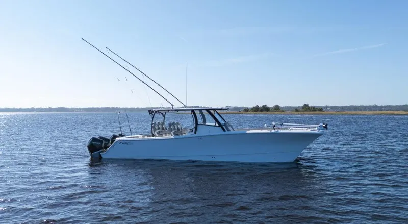  Yacht Photos Pics 2026 Front Runner 37 Catamaran on calm water, equipped with fishing rods.