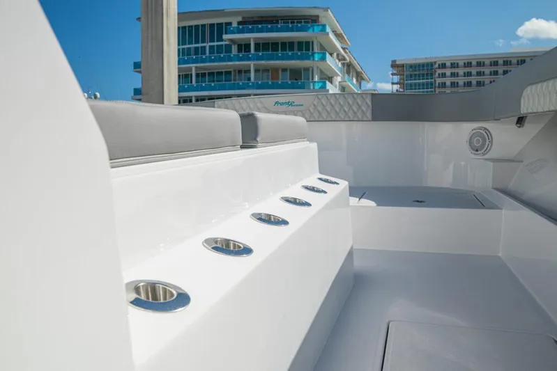  Yacht Photos Pics 2026 Front Runner 37 Catamaran interior with rod holders, modern design, and urban backdrop.