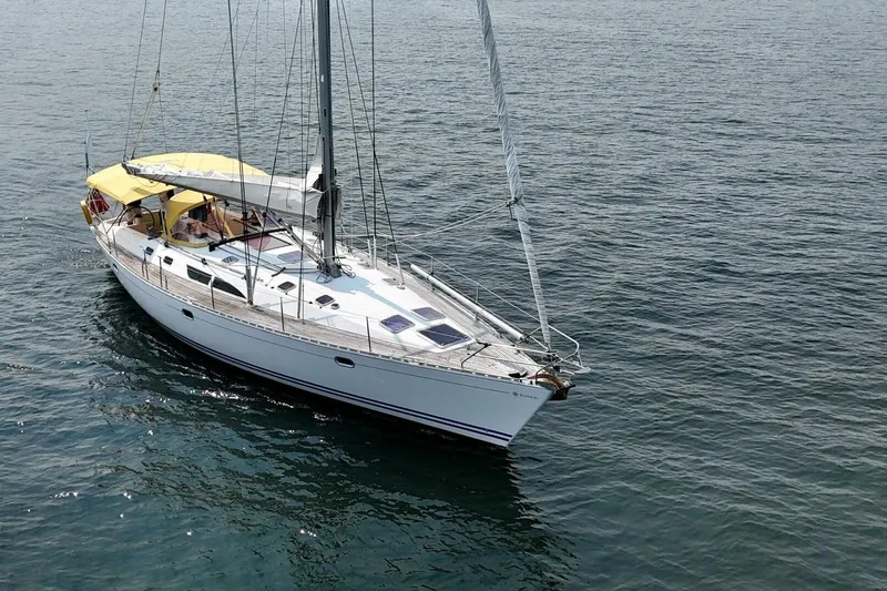 Free Spirits Yacht Photos Pics Jeanneau Sun Odyssey 45.2 sailboat from 2000 on calm ocean waters.
