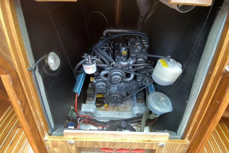 Free Spirits Yacht Photos Pics Engine compartment of a 2000 Jeanneau Sun Odyssey 45.2 sailboat, showcasing detailed mechanics.