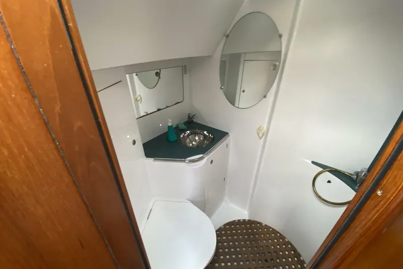 Free Spirits Yacht Photos Pics Bathroom interior of 2000 Jeanneau Sun Odyssey 45.2 yacht, featuring sink and mirror.