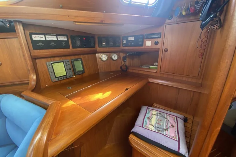 Free Spirits Yacht Photos Pics Interior of 2000 Jeanneau Sun Odyssey 45.2 yacht with navigation equipment and wooden cabinetry.