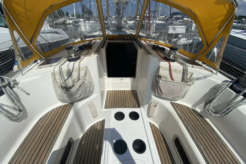 Free Spirits Yacht Photos Pics Cockpit of 2000 Jeanneau Sun Odyssey 45.2 sailboat with yellow canopy and teak flooring.