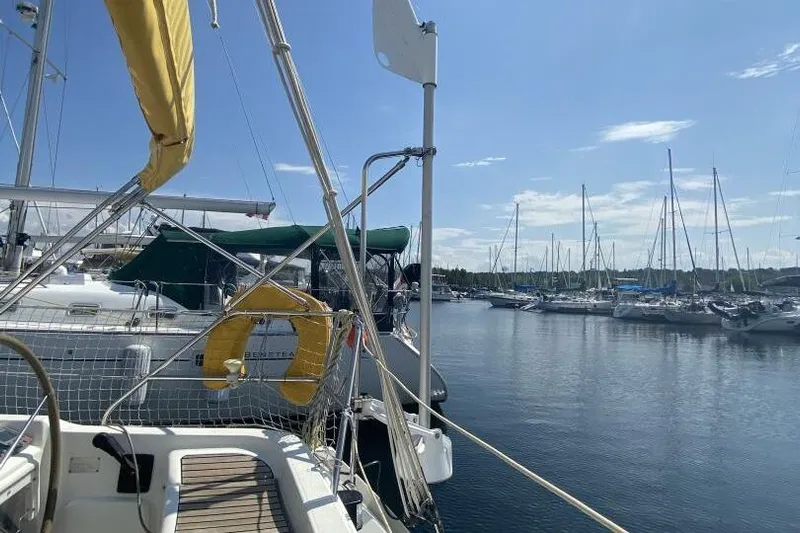 Free Spirits Yacht Photos Pics Jeanneau Sun Odyssey 45.2 sailboat docked in a marina, sunny day, 2000 model.