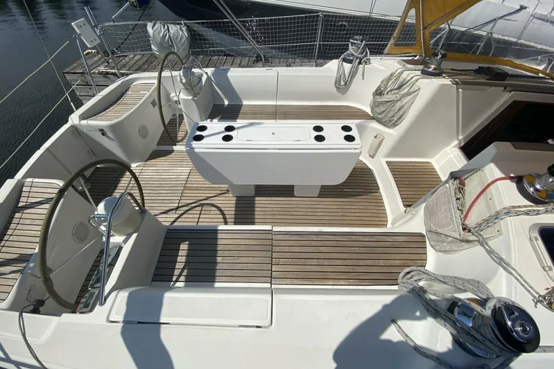 Free Spirits Yacht Photos Pics Cockpit of 2000 Jeanneau Sun Odyssey 45.2 sailboat with dual steering wheels and teak flooring.