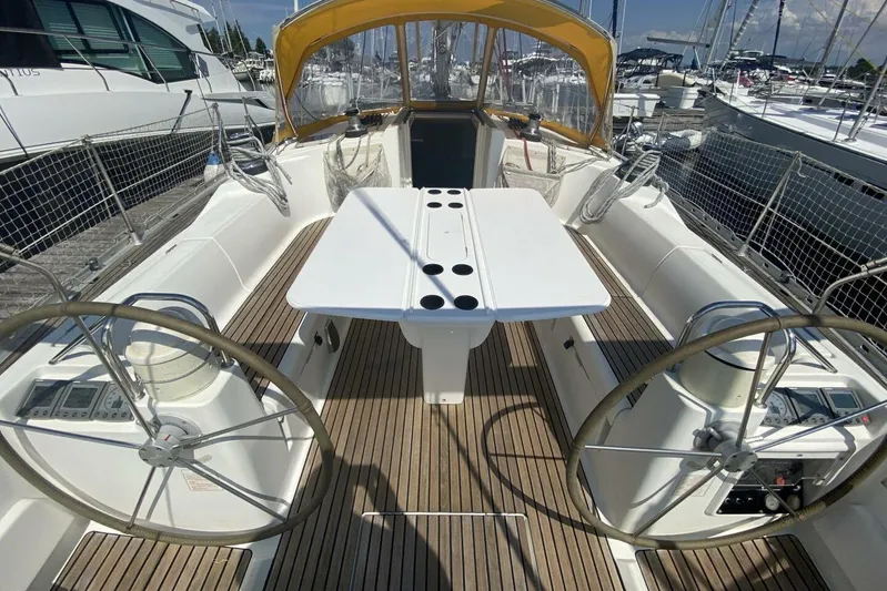 Free Spirits Yacht Photos Pics Cockpit of 2000 Jeanneau Sun Odyssey 45.2 sailboat with dual steering wheels and teak decking.