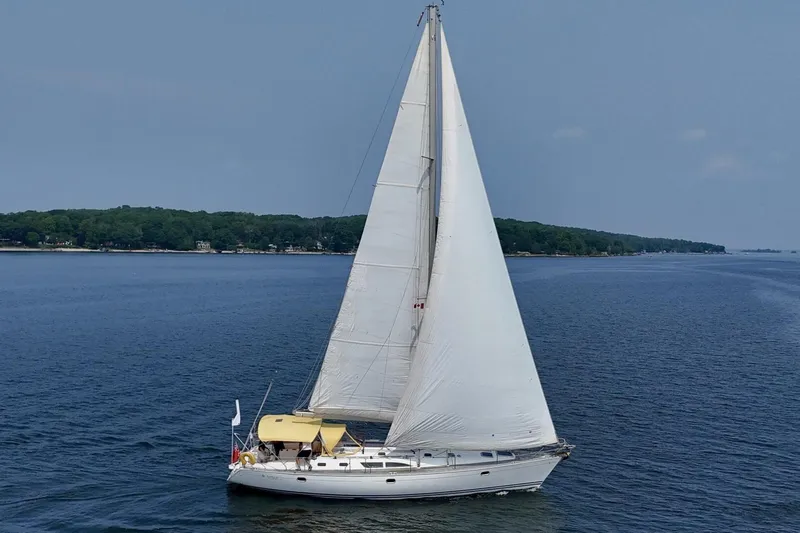 Free Spirits Yacht Photos Pics Jeanneau Sun Odyssey 45.2 sailing on calm waters, 2000 model yacht.
