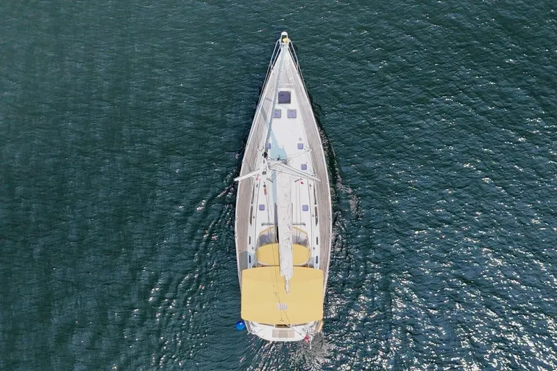 Free Spirits Yacht Photos Pics Aerial view of 2000 Jeanneau Sun Odyssey 45.2 sailboat on open water.