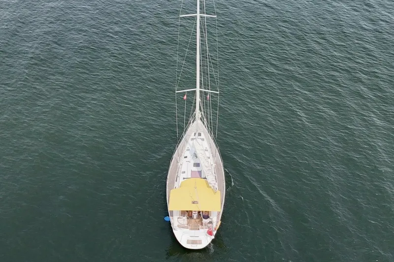 Free Spirits Yacht Photos Pics Aerial view of 2000 Jeanneau Sun Odyssey 45.2 sailboat on open water.