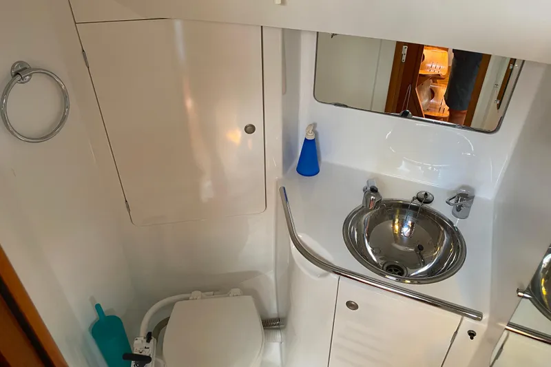 Free Spirits Yacht Photos Pics Bathroom interior of 2000 Jeanneau Sun Odyssey 45.2 yacht, featuring sink and toilet.