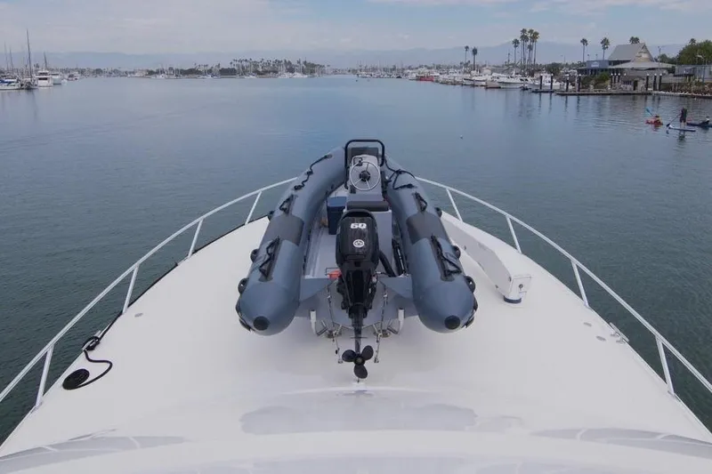 Serenity Now Yacht Photos Pics 2014 Viking 66 Convertible yacht with inflatable boat on deck, docked in a marina.