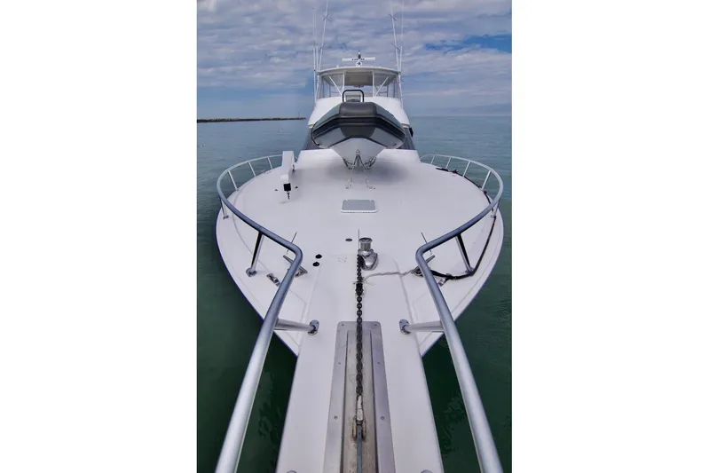 Serenity Now Yacht Photos Pics 2014 Viking 66 Convertible yacht on calm water, showcasing sleek design and spacious deck.