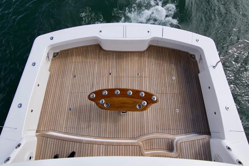 Serenity Now Yacht Photos Pics 2014 Viking 66 Convertible yacht deck with teak flooring and fishing rod holders.