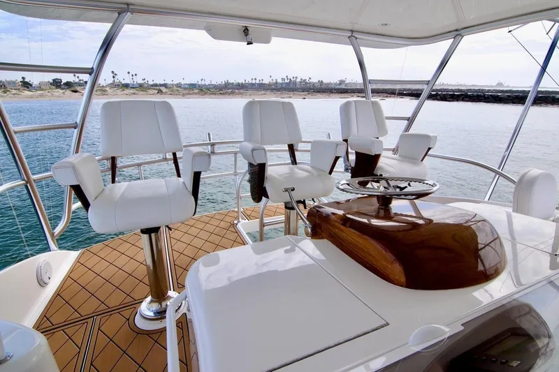 Serenity Now Yacht Photos Pics Luxury Viking 66 Convertible yacht interior with white seating, overlooking serene ocean view.