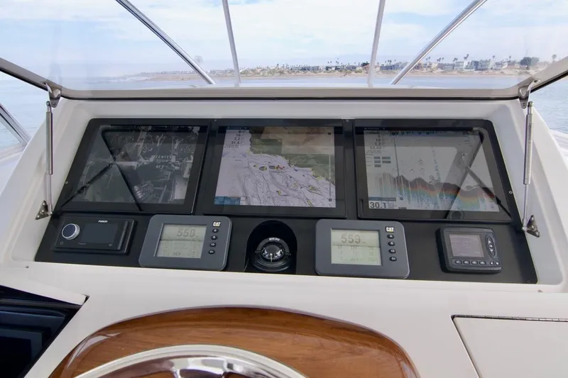 Serenity Now Yacht Photos Pics Dashboard of 2014 Viking 66 Convertible yacht with navigation and control displays.