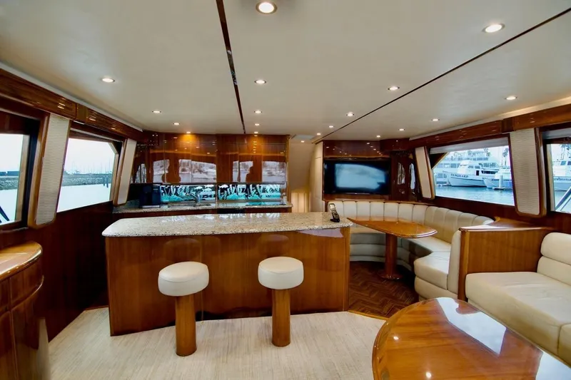 Serenity Now Yacht Photos Pics Luxurious interior of 2014 Viking 66 Convertible yacht with elegant wood finishes and seating.