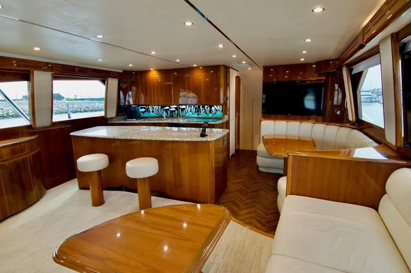 Serenity Now Yacht Photos Pics Luxurious interior of 2014 Viking 66 Convertible yacht with elegant wood finishes and seating.