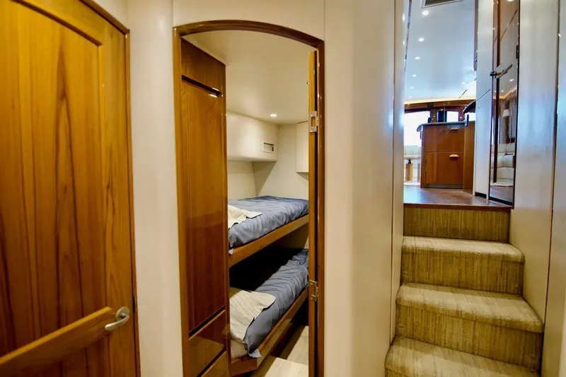 Serenity Now Yacht Photos Pics Interior of 2014 Viking 66 Convertible yacht with bunk beds and wooden finishes.