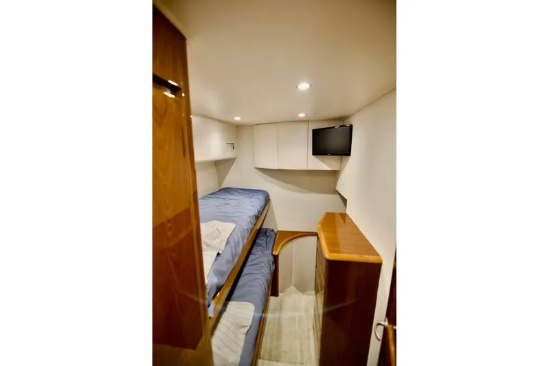 Serenity Now Yacht Photos Pics Interior cabin of 2014 Viking 66 Convertible yacht with twin beds and TV.