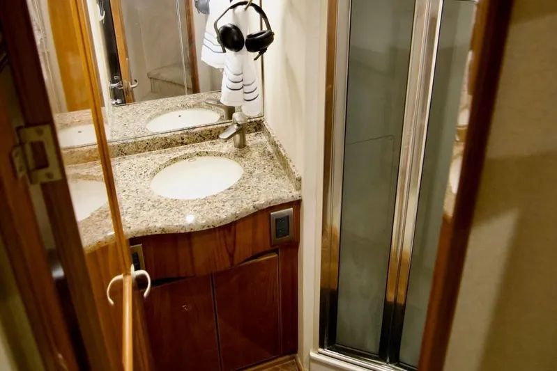 Serenity Now Yacht Photos Pics Luxurious bathroom in 2014 Viking 66 Convertible yacht with granite countertop and shower.