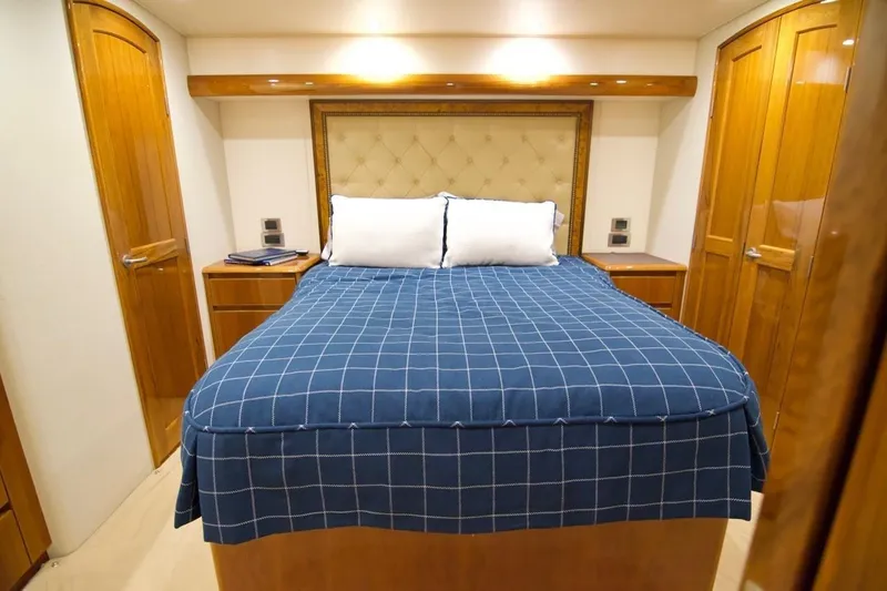 Serenity Now Yacht Photos Pics Luxurious bedroom interior of 2014 Viking 66 Convertible yacht with elegant wood finishes.