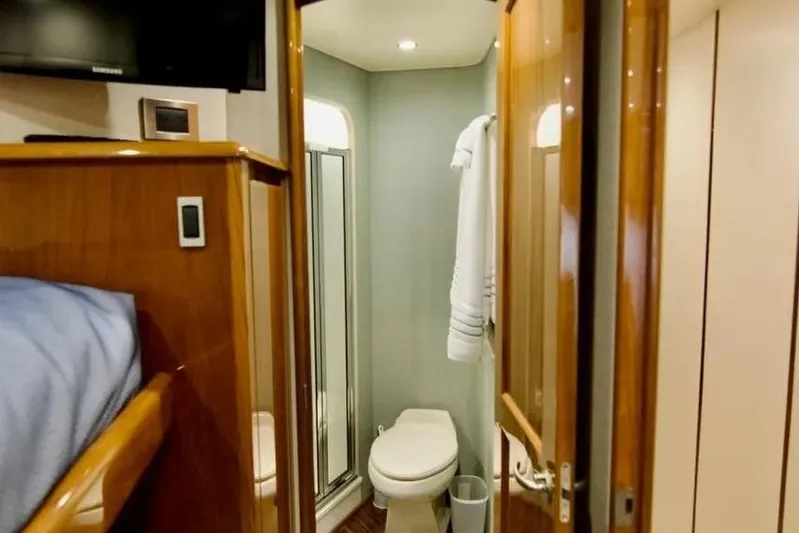 Serenity Now Yacht Photos Pics Interior of 2014 Viking 66 Convertible yacht bathroom with shower and toilet.