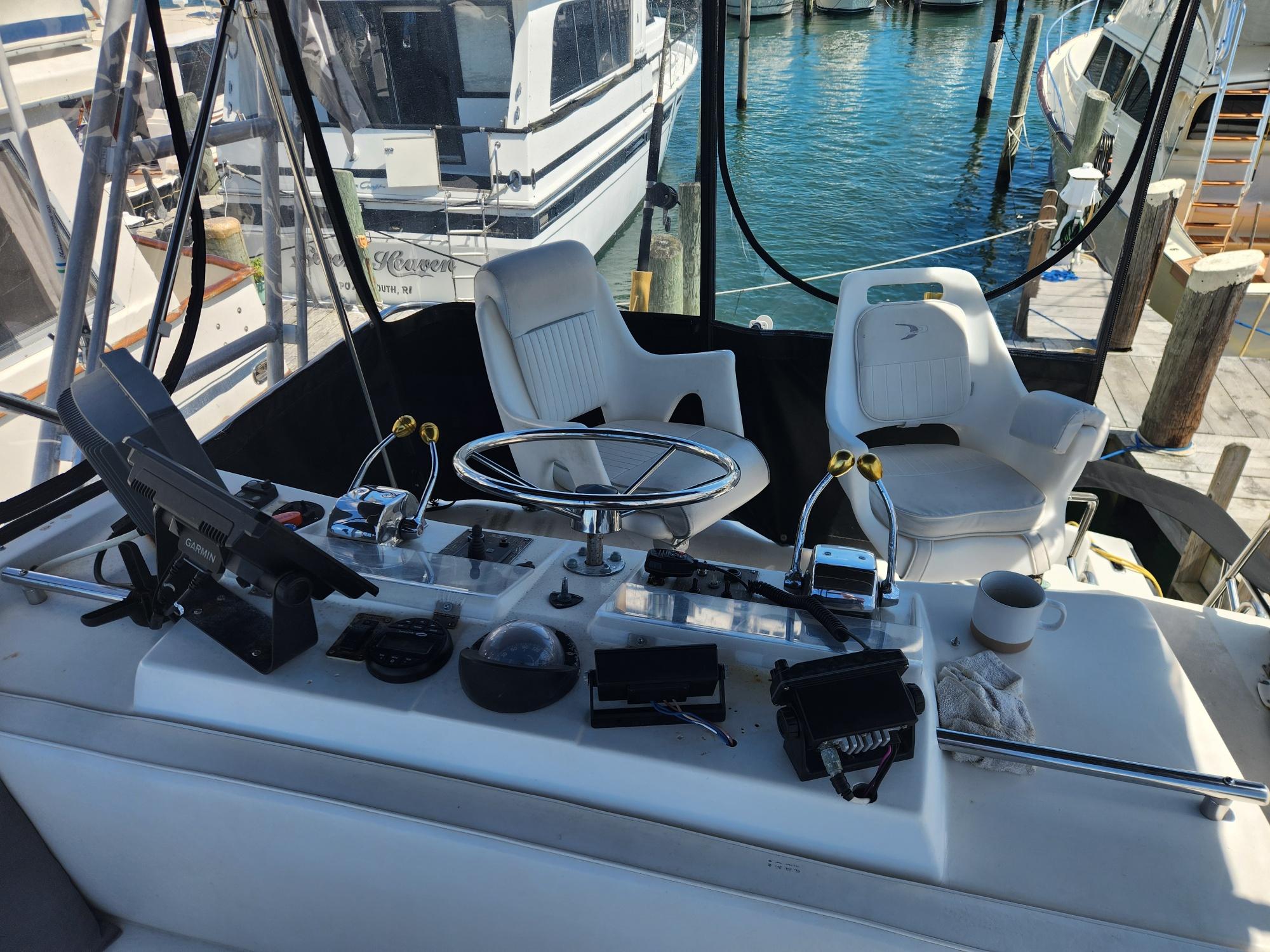 Cockpit of a 1977 Pacemaker 40 Sportfisherman with steering wheel and controls.