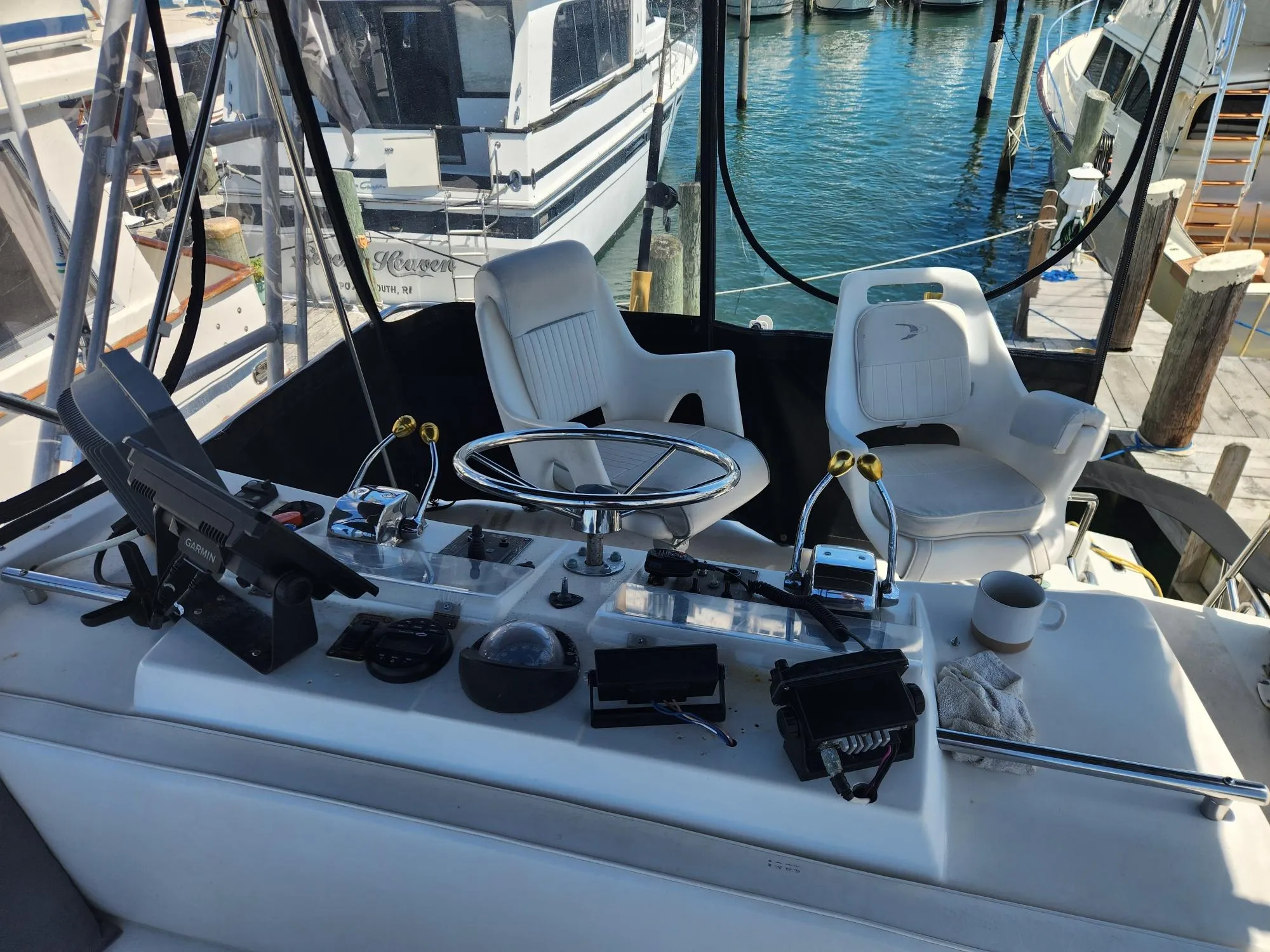 Cockpit of a 1977 Pacemaker 40 Sportfisherman with steering wheel and controls.